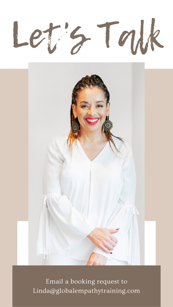 A woman in white shirt and black earrings.