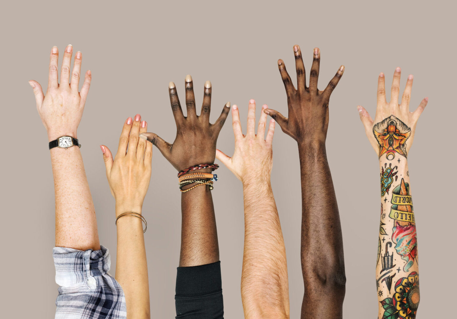 A group of people raising their hands in the air.